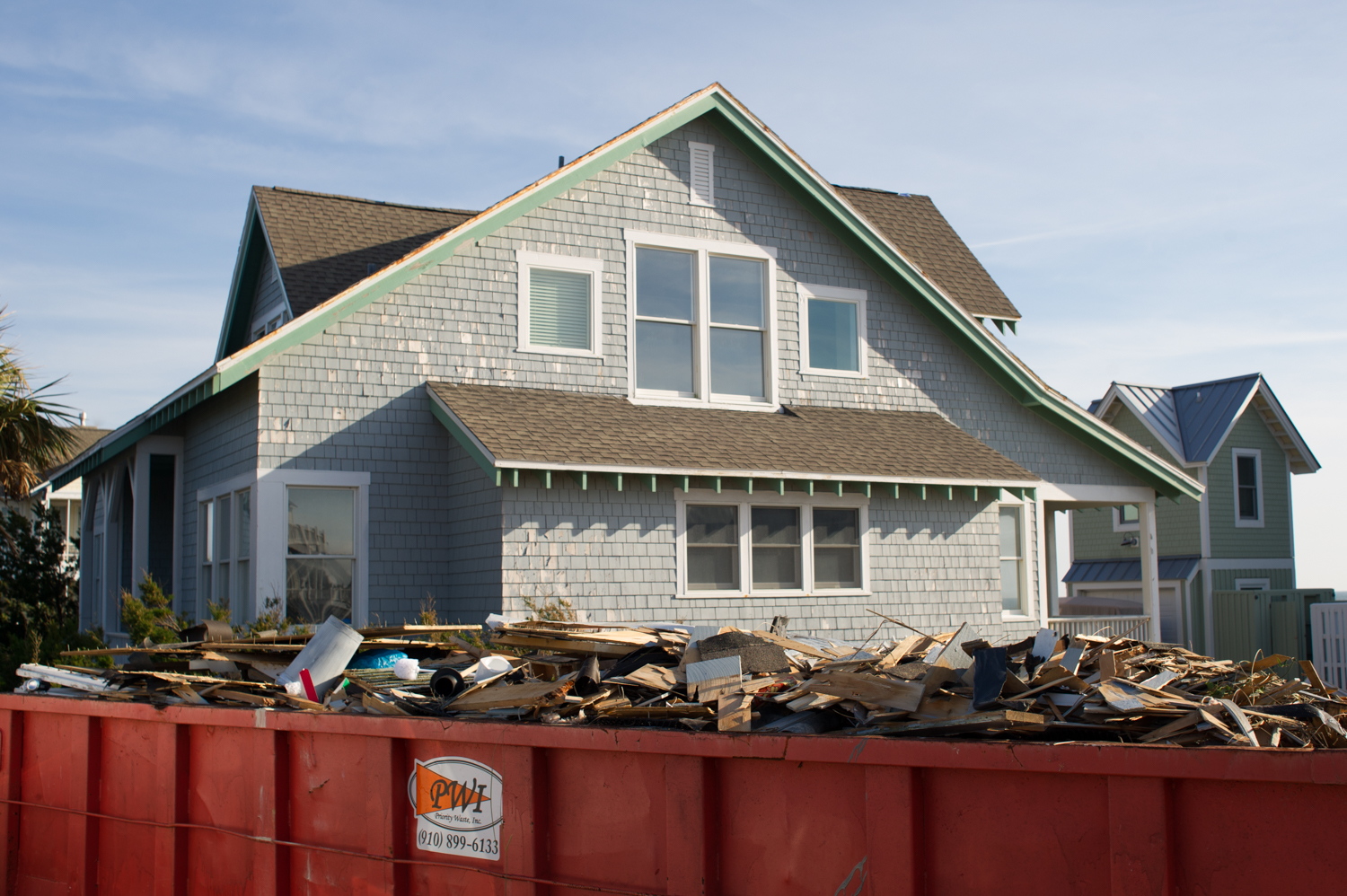 Dumpsters still overfilled with debris were seen outside homes along South Bald Head Wynd. (Port City Daily photo/Mark Darrough)