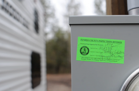 A Pender County permit tag for an electrical pole that Burgaw resident Stephanie Kramer said was an unnecessary requirement made by a FEMA contractor. (Port City Daily photo/Mark Darrough)