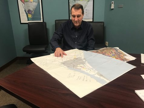 New Hanover County Planning and Land Use Director Wayne Clark with a map of potential commercial and residential growth areas in the northern part of the county. (Port City Daily photo / Benjamin Schachtman)