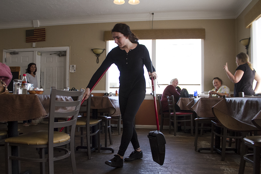 Lauren Costa, Claudia and the late Gene Costa's daughter cleans up at Bon Appetit after one of her last shifts at the restaurant. Just a couple years older than the restaurant itself, Costa said she helped out in the restaurant since she was 14. (Port City Daily photo/Johanna Ferebee)