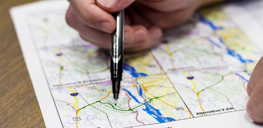 Chad Kimes, North Carolina Department of Transportation deputy division engineer, outlines an approximate area outside the proposed four-lane roadway system that will be studied during the merger and design process of Cape Fear Crossing. (Port City Daily/photo Johanna Ferebee)