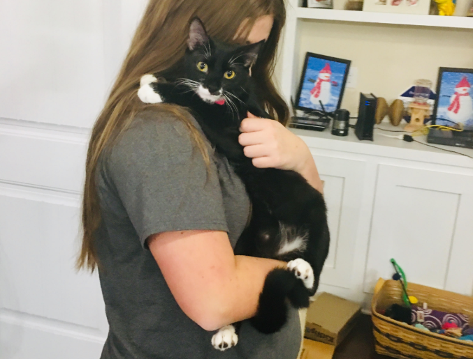 Tiff snuggles with one of her favorite humans, Brianna Filyaw. (Port City Daily photo / Samira Davis)