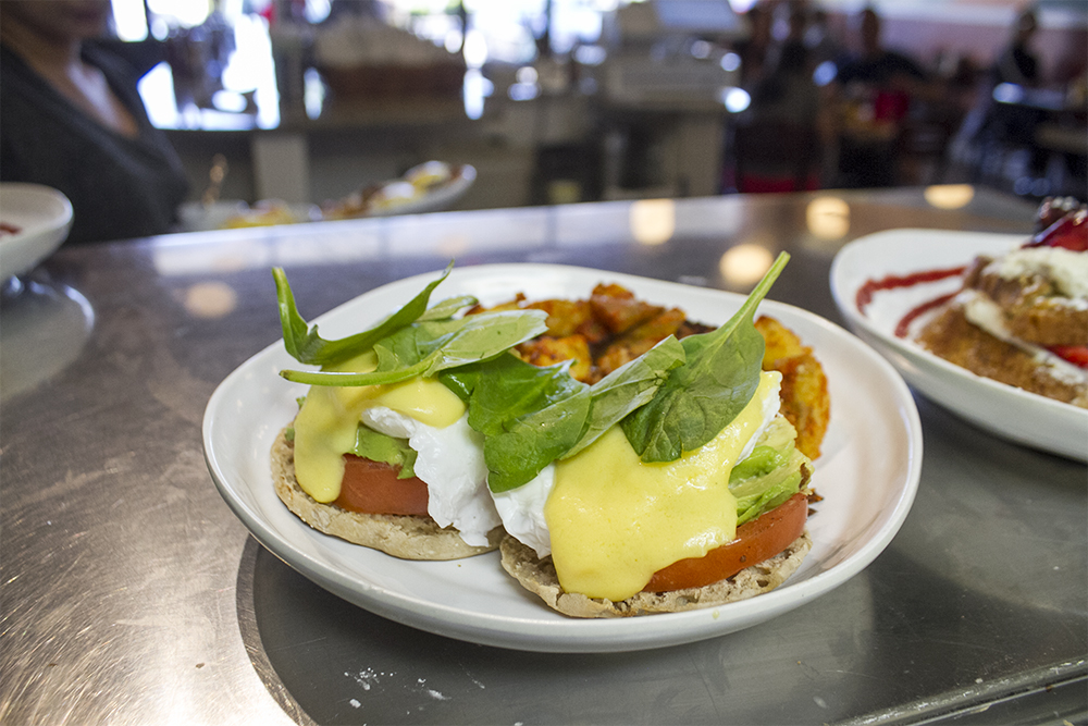 The California Benedict is made with a whole wheat english muffin, tomato, avocado, poached eggs, hollandaise and is topped with fresh spinach. (Port City Daily photo/Johanna Ferebee)