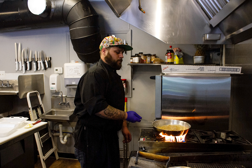 Kory Sanderson fires up smoked, creamy maple syrup which is paired with donut-style waffles. (Port City Daily photo/Johanna Ferebee)