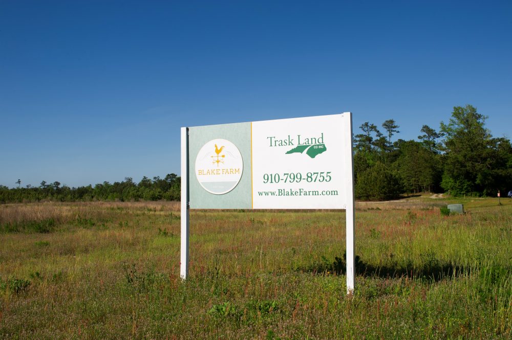 A sign for Blake Farm and developer Trask Land Company sits off U.S. 17 just north of the New Hanover-Pender county line. (Port City Daily photo/Mark Darrough)