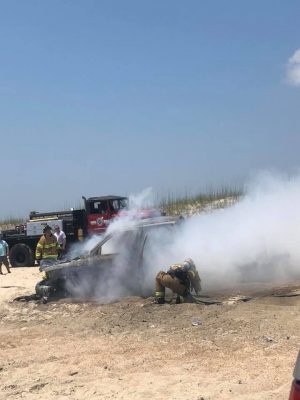Photos show firefighters responding to a burning vehicle on Carolina Beach (Port City Daily/Kate Taylor via Facebook)