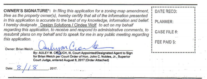 Attorney Auley Crouch signed for Brian Welch as part of the rezoning application for the Kerr Station Lofts project. (Port City Daily photo / Benjamin Schachtman)