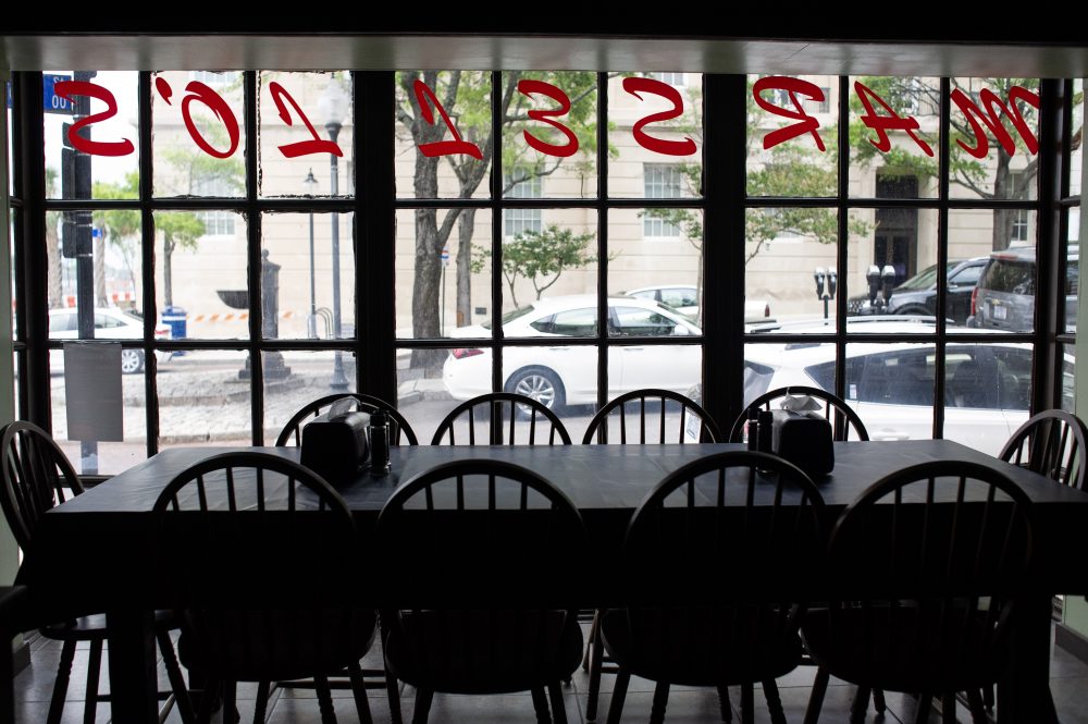 A table in the first floor dining room looks out on Market Street in downtown Wilmington. (Port City Daily photo/Mark Darrough)