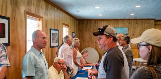 From Surf City Councilman Jeremy talks with a resident following a special meeting last week that saw approval of the Surf City Crossing apartment complex. (Port City Daily photo/Mark Darrough)
