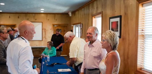 Evolve Companies Director of Acquisitions and Development Matt Rogers, left, speaks to Surf City Mayor Doug Medlin and Councilmember Teresa Batts after the preliminary approval of Evolve's Surf City Crossing luxury apartments. To Rogers left is Wilmington attorney and former state senator Michael Lee, who in November lost a close state senate race after a recount. (Port City Daily photo/Mark Darrough)