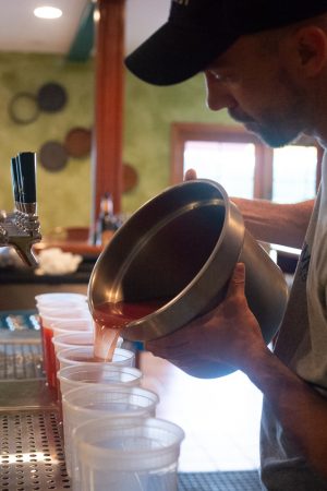 A hazy IPA broth is prepared for the Hazy Cajun Boil – sausage, corn, potatoes, shrimp, local clams, smoked crab legs, and boiled peanuts. (Port City Daily photo/Mark Darrough)