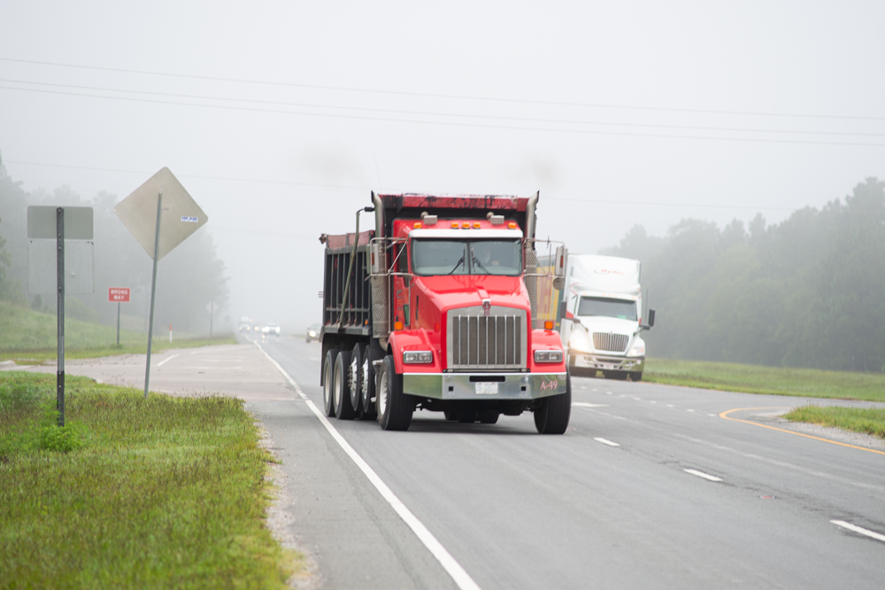 A truck exits the Pender Commerce Park onto U.S. 421. The park's proximity to the highway and to the Cape Fear River, which connects to the Port of Wilmington, is a draw to companies relocating to the area. (Port City Daily photo/Mark Darrough)