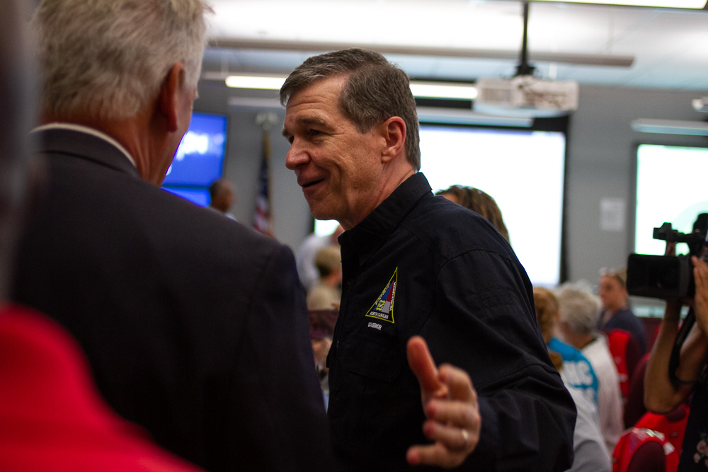 (Center) Governor Roy Cooper talks to New Hanover County Commissioner Rob Zapple in the New Hanover County Emergency Operations Center Tuesday morning. (Port City Daily photo/Johanna Ferebee)