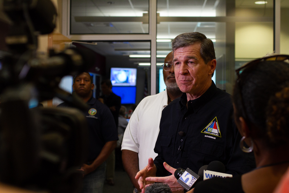 Governor Roy Cooper addresses the press in the New Hanover County Emergency Operations Center Tuesday morning to prepare for Hurricane Dorian, accompanied by (right) New Hanover County Chairman Jonathan Barfield. (Port City Daily photo/Johanna Ferebee)