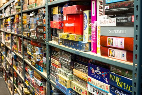 A row of shelves that currently house Darryl Rubin's collection of old and rare games inside the warehouse space behind Cape Fear Games. (Port City Daily photo/Mark Darrough)