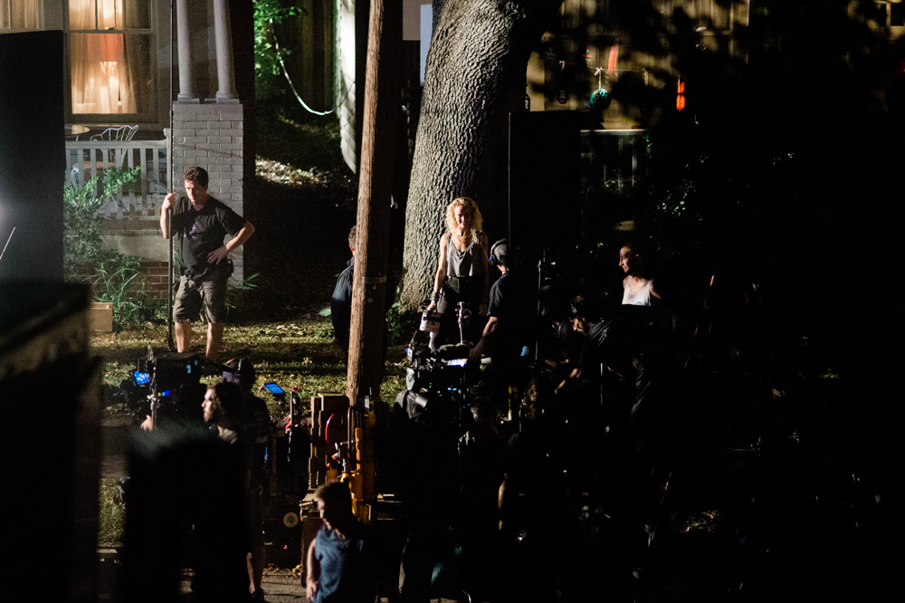 A woman, center, holds the clapperboard marking the start of filming a scene on Pender Avenue. (Port City Daily photo/Mark Darrough)