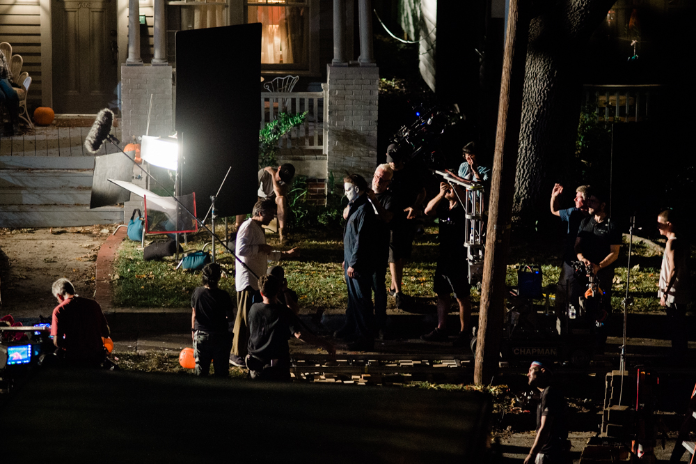 A crew member applies the iconic "Halloween" mask to the actor playing serial murderer Michael Myers. (Port City Daily photo/Mark Darrough) 