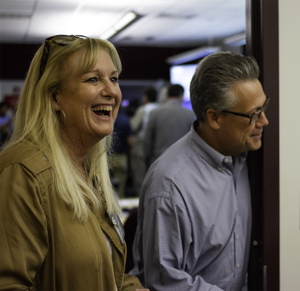 New Hanover County public information officer Janine Powell (left) and Manager Chris Coudriet greet employees in the Joint Communication Center tasked with fielding calls from the public information hotline. (Port City Daily photo/Johanna Ferebee)