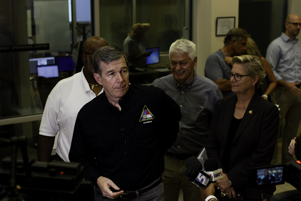 (Left) Governor Roy Cooper prepares to address the press in the New Hanover County Emergency Operations Center Tuesday morning to prepare for Hurricane Dorian, accompanied by (center) Senator Harper Peterson and (right) Representative Deb Butler. (Port City Daily photo/Johanna Ferebee)