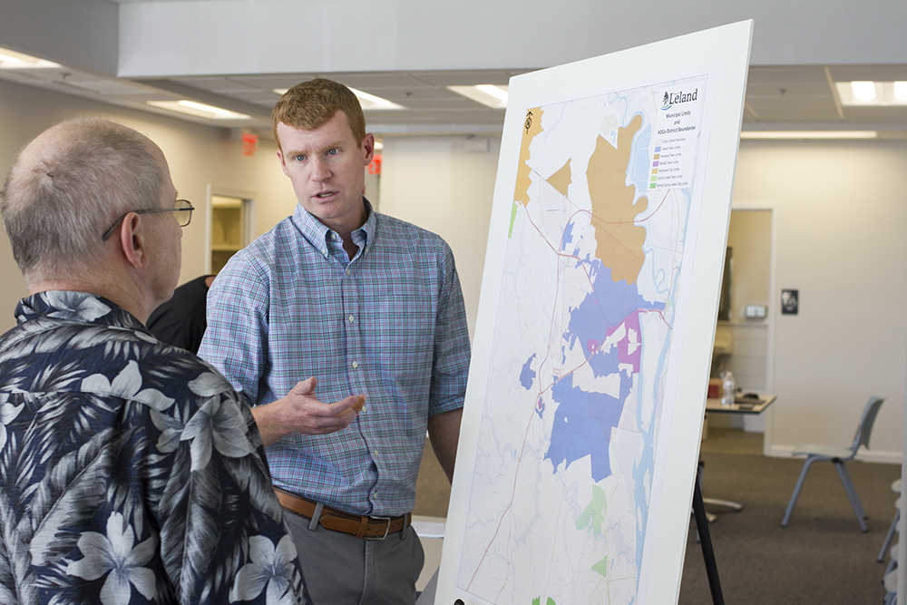 Leland assistant town manager Niel Brooks explains the petition process to a Brunswick Forest resident Friday. (Port City Daily photo/Johanna Ferebee)