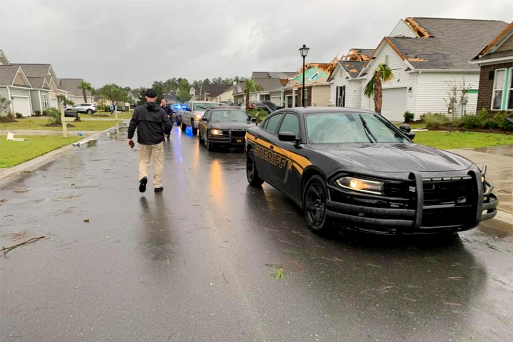 Sheriff John Ingram walks through The Farm, a neighborhood in Carolina Shores that experienced a weather event that resembles a tornado early Thursday morning as Hurricane Dorian moves closer to the coastline. (Port City Daily photo/Courtesy Brunswick County Sheriff's Office)