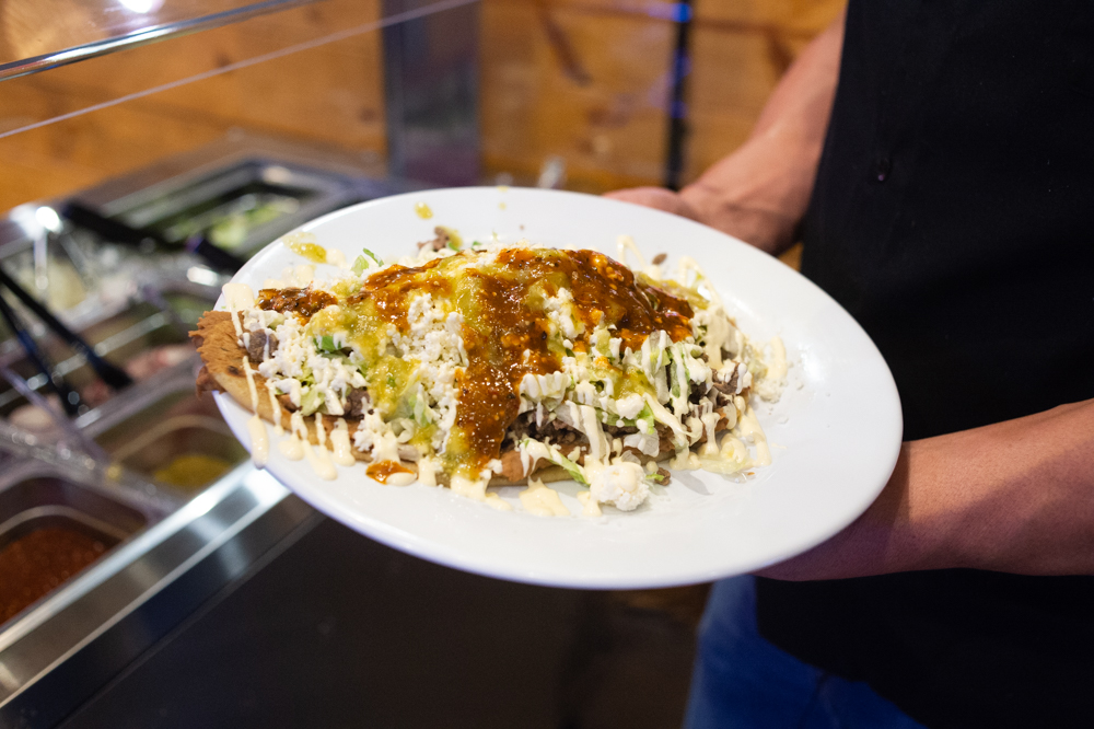 Huarache, a popular Mexican street dish made with thick corn masa flatbread topped with refried beans and ground beef, beef toungue, or other meats and queso fresco. (Port City Daily photo/Mark Darrough)
