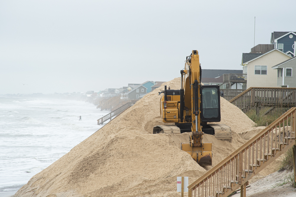 Sand-hauling work was scheduled to begin Monday, but is delayed until beach engineers assess the damages from the storm. Here, a sand pile recently dumped just south of the Surf City Pier. (Port City Daily photo/Mark Darrough)