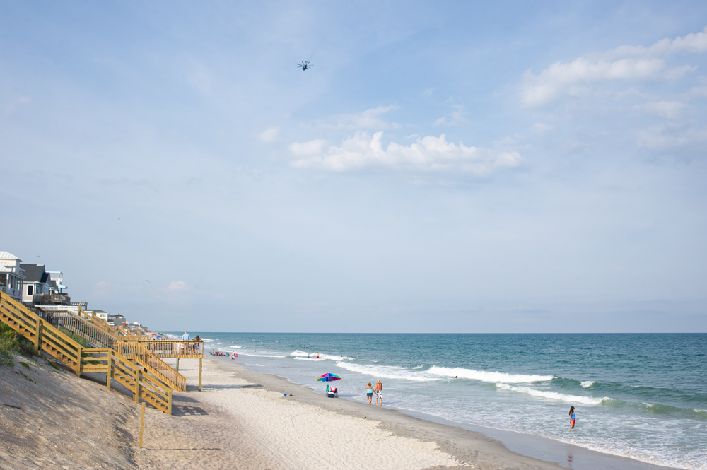 A helicopter from Camp Lejuene passes over the beach of Surf City. (Port City Daily photo/Mark Darrough)