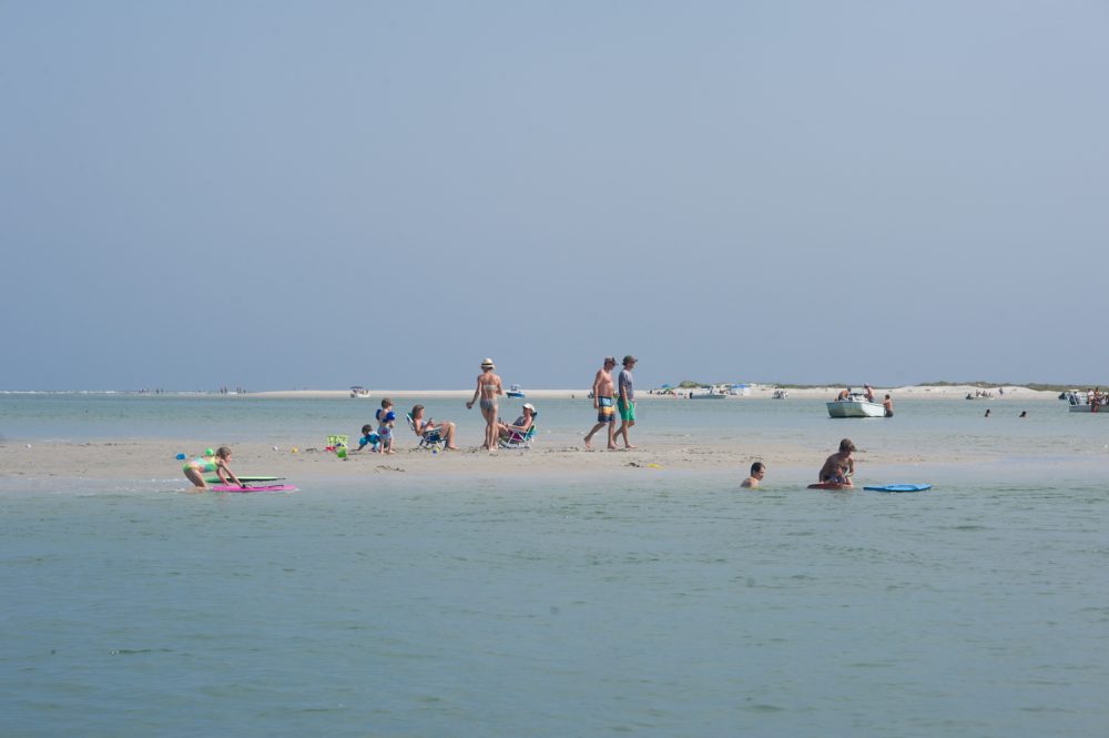 Beach-goers relax on a sand bar in Mason Inlet at the north end of Wrightsville Beach. (Port City Daily photo/Mark Darrough)