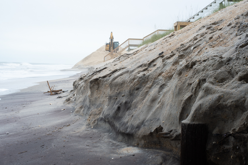 Erosion beneath the Surf City Ocean Pier after a Northeaster hit Topsail Island in November, causing escarpments along the dunes and wiping out recently built emergency berms. (Port City Daily photo/Mark Darrough)