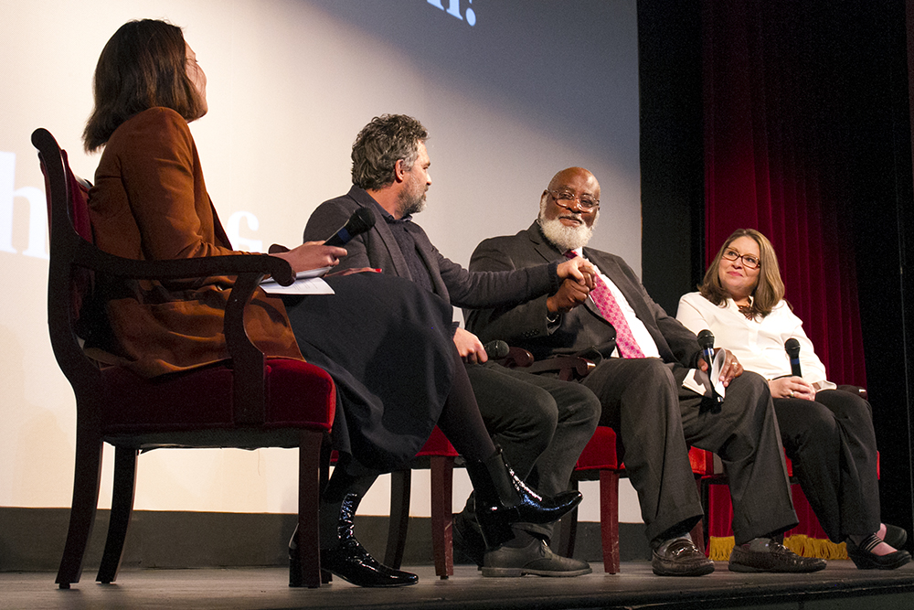 Actor Mark Ruffalo (center left) and New Hanover County Chairman Jonathan Barfield hold hands during the panel ahead of the "Dark Waters" screening at Thalian Hall. (Port City Daily photo/Johanna F. Still)