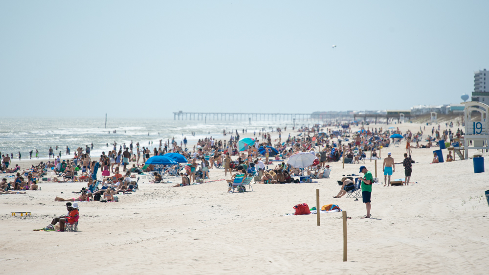 Young visitors look for a spot to set up at Carolina Beach on Friday afternoon. (Port City Daily photo/Mark Darrough)