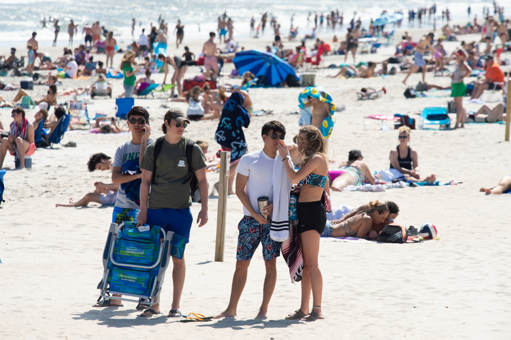 Young visitors look for a place to set up at Carolina Beach early Friday afternoon. (Port City Daily photo/Mark Darrough)