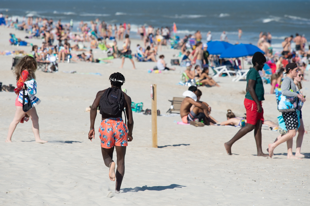 A young man runs along Carolina Beach Friday afternoon. (Port City Daily photo/Mark Darrough)