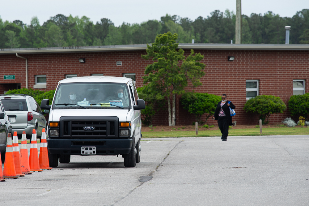 Staff at the Pender Correctional Institution sit in a van on Thursday wearing face masks and checking the temperatures of employees entering the facility. (Port City Daily photo/Mark Darrough)