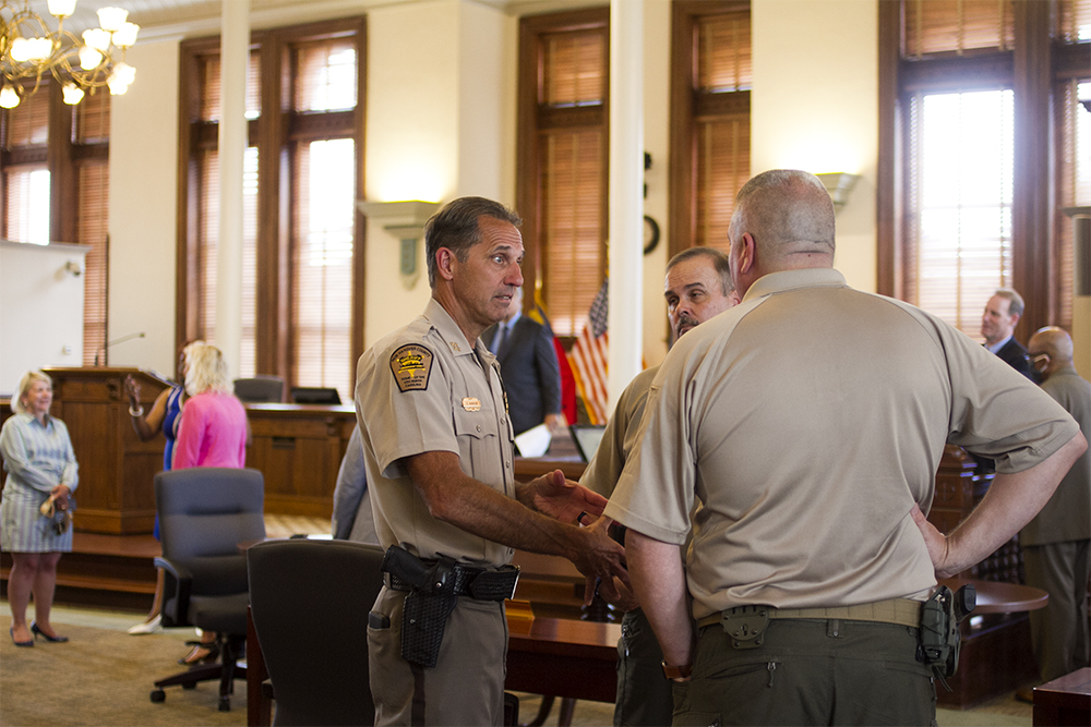 New Hanover County Sheriff Ed McMahon speaks with Chief Deputy Ken Sarvis and Lt. Jerry Brewery before the press conference. (Port City Daily photo/Johanna F. Still)