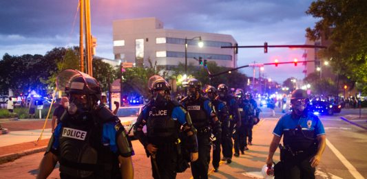 Wilmington Police riot officers walk down Chestnut Street during a late May protest. Weeks later, three WPD officers were fired weeks later after unintentionally recorded conversations went public revealing racist and violent language. (Port City Daily photo/Mark Darrough)