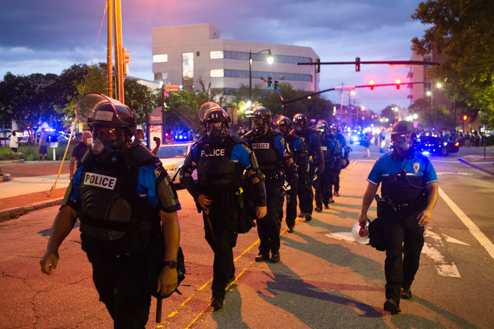 Wilmington Police riot officers walk down Chestnut Street during a late May protest. Weeks later, three WPD officers were fired weeks later after unintentionally recorded conversations went public revealing racist and violent language. (Port City Daily photo/Mark Darrough)