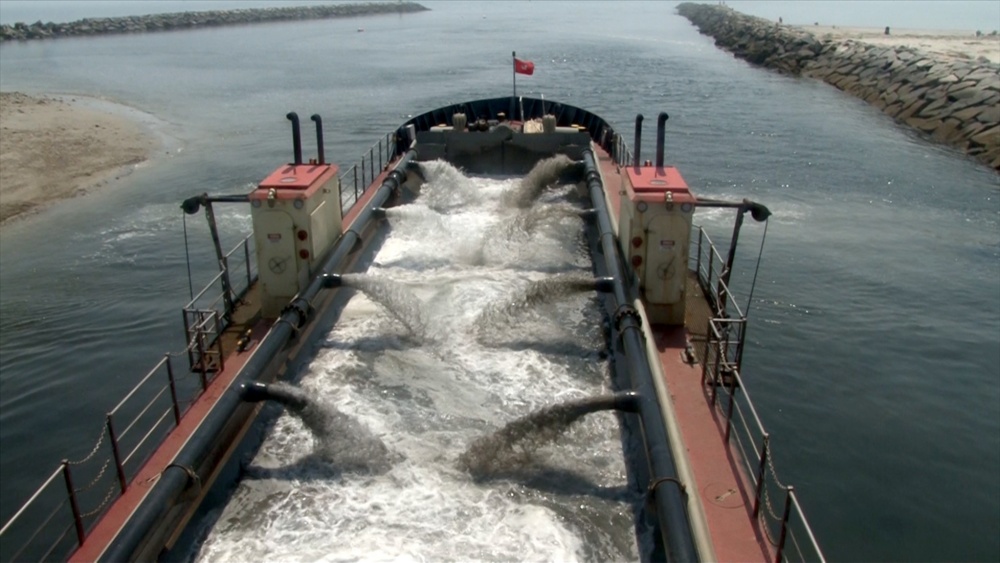 A hopper dredge pulls material into its hull in 2013 in the USACE New England district. Note: The appearance of U.S. Department of Defense (DoD) visual information does not imply or constitute DoD endorsement. (Port City Daily photo/Courtesy Defense Visual Information Distribution Service)
