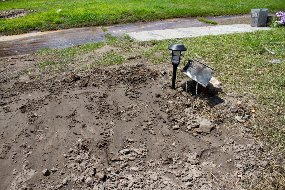 The still-fresh gravesite of Koredreese R. Tyson was desecrated in the early morning hours Aug. 11, where arsonists burned arrangements and a funeral tent. (Port City Daily photo/Johanna F. Still)