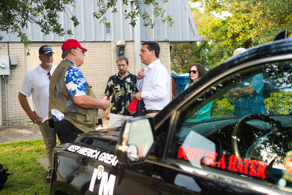 U.S. Congressman David Rouzer swaps business cards with a rally attendee Wednesday evening. (Port City Daily photo/Mark Darrough)