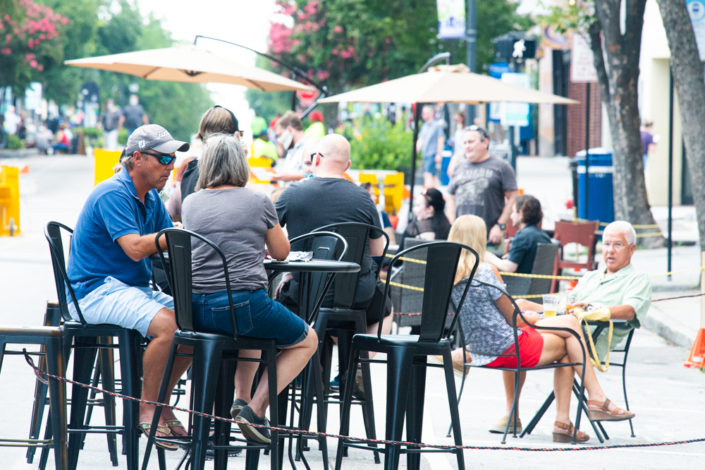Patrons eat at tables lined up along Front Street Thursday evening as part of Downtown Alive's initiative to expand seating areas for downtown restaurants. (Port City Daily photo/Mark Darrough)
