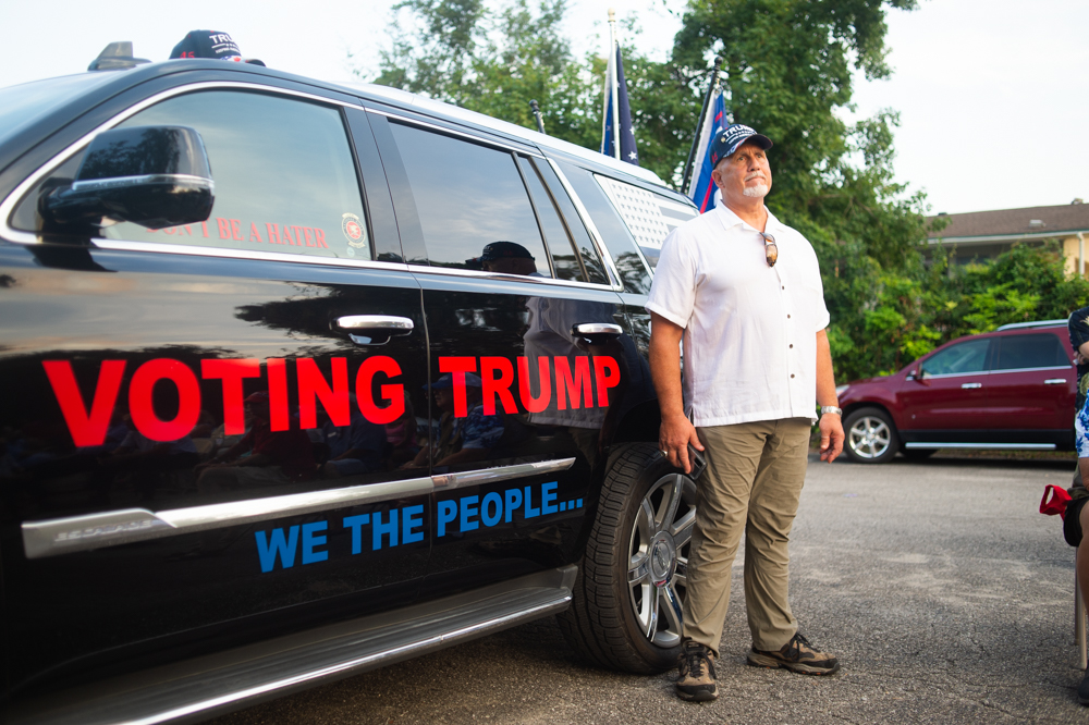 Matt DiGioia stands by his SUV as Congressman David Rouzer speaks. He said he added the Trump decorations and slogans to his car about 10 days ago. (Port City Daily photo/Mark Darrough)