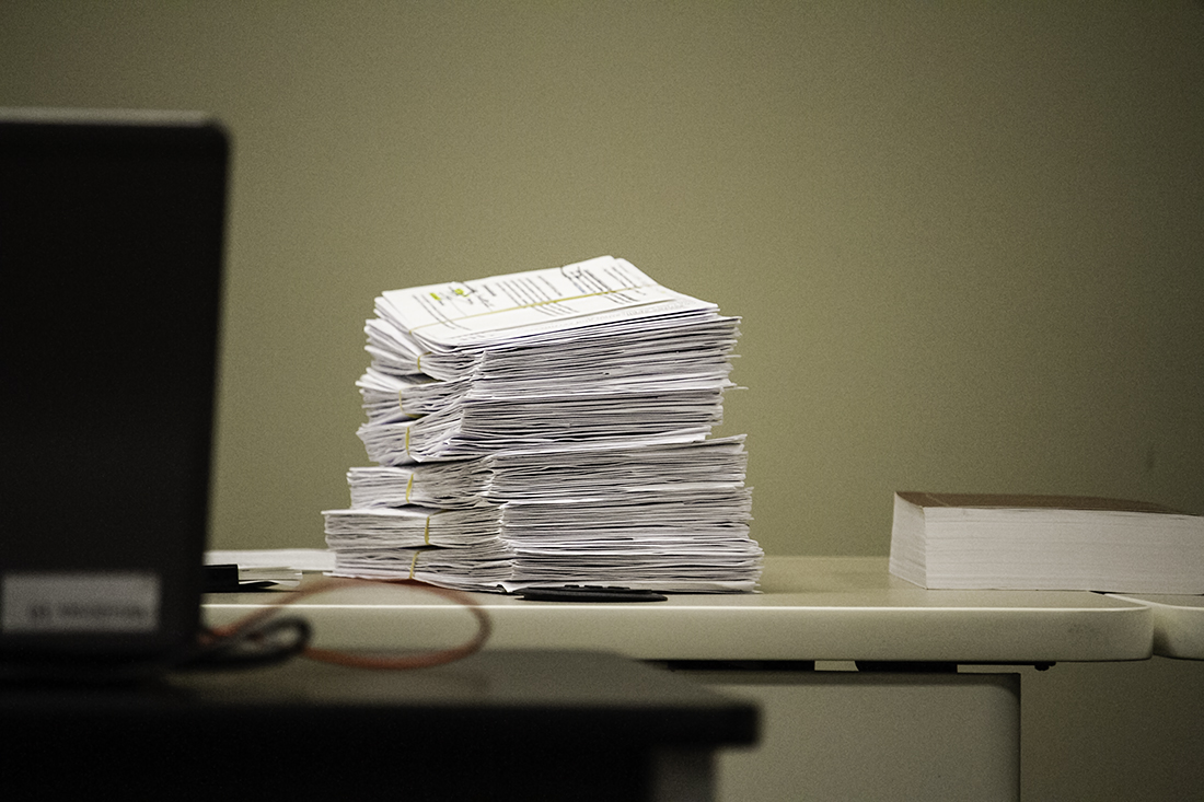 A stack of absentee by-mail ballots awaits inspection at the New Hanover County Board of Elections meeting Thursday. (Port City Daily photo/Johanna F. Still)