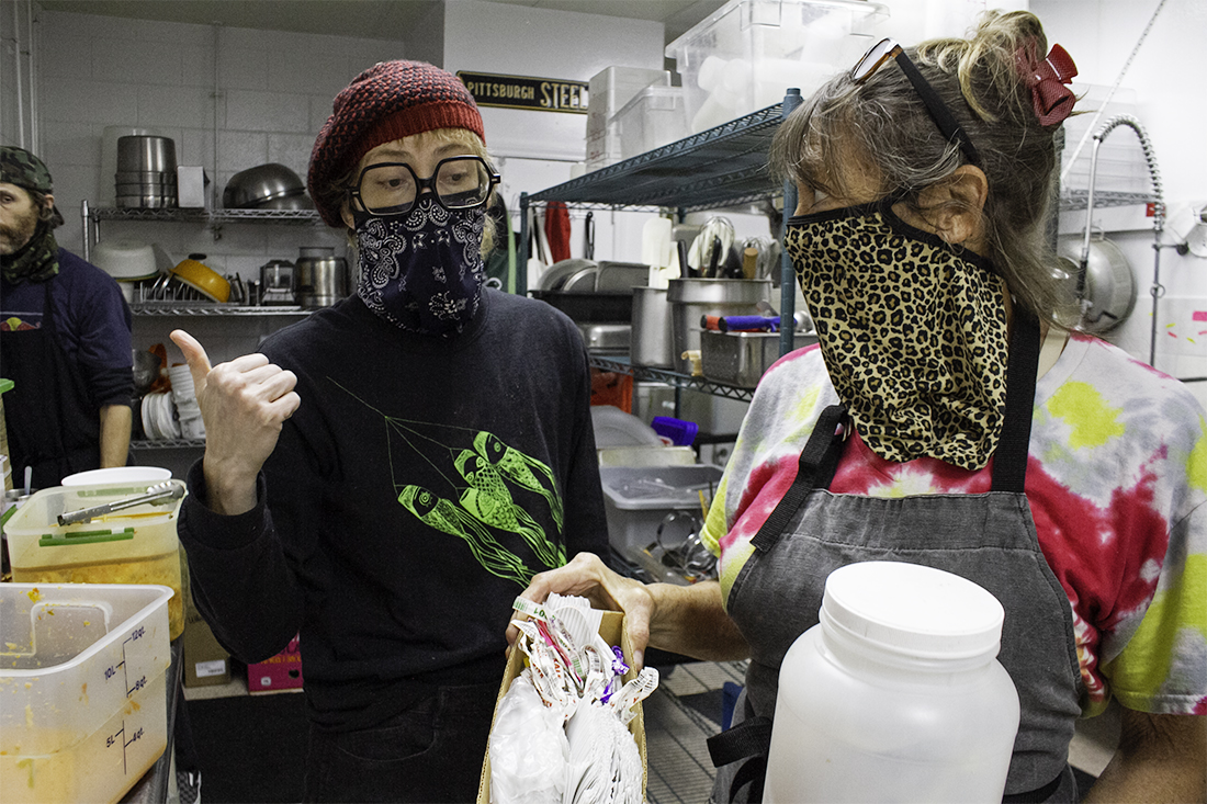 Cherry Gibbs (right) holds containers of rubber bands and plastic ties her daughter, Kelsey, saves in order to reuse the products at Sealevel City Vegan Diner. (Port City Daily photo/Johanna F. Still)